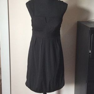 Structured black dress with tufted hem.